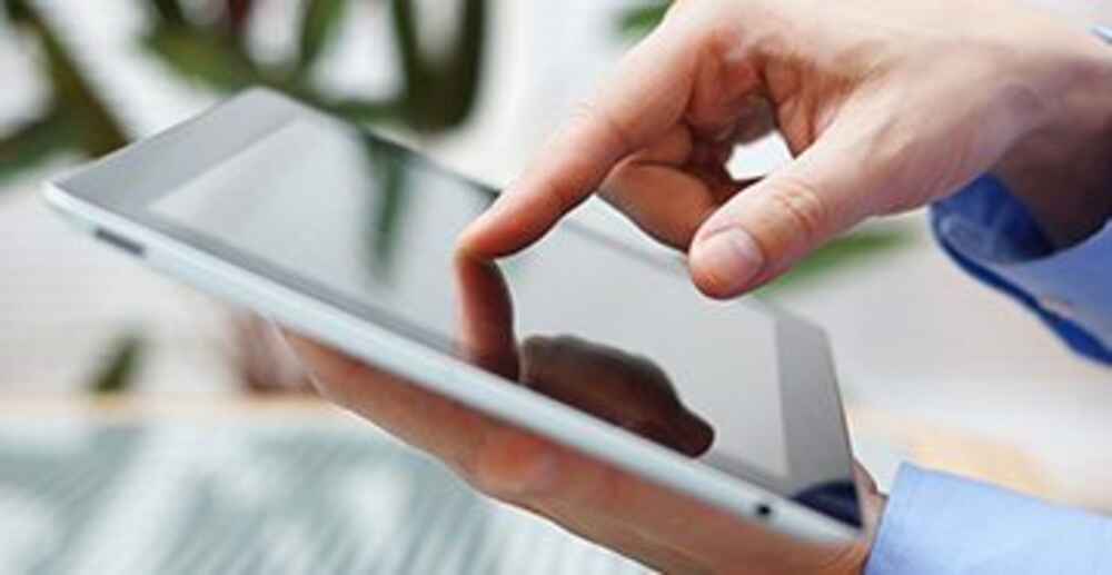 Person pressing finger on tablet